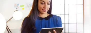 A woman looking at her tablet