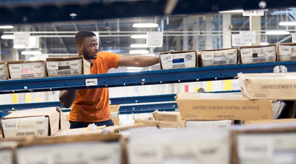 man working in mail sorting facility